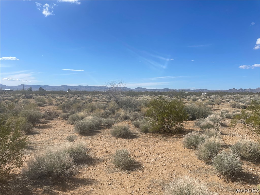 3999 Verde Road Golden Valley, AZ 86413 - Photo 7 of 18 a view of a dry yard with mountains