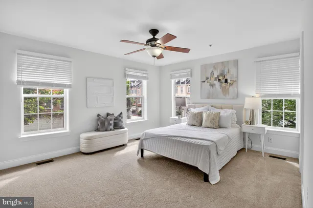 a bedroom with a bed chandelier and window