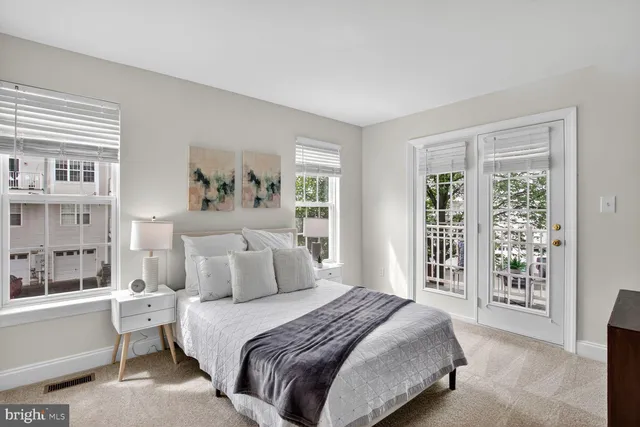 a bedroom with a large bed and a window