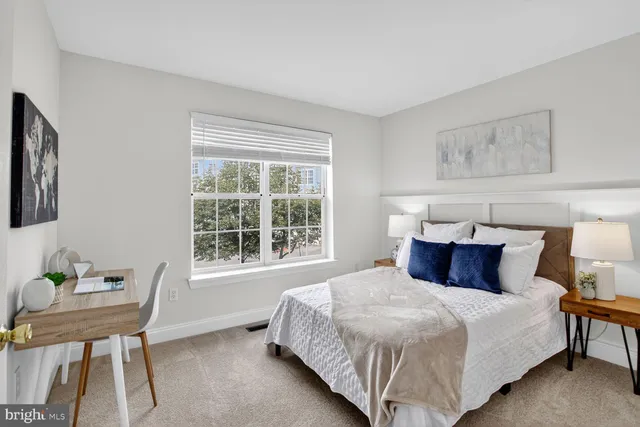 a bedroom with a bed a table and chair