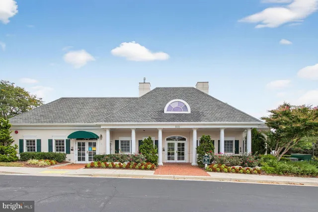 a front view of a house with lots of flower plants