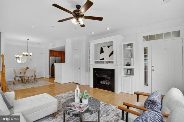 a living room with furniture a fireplace with wooden floor