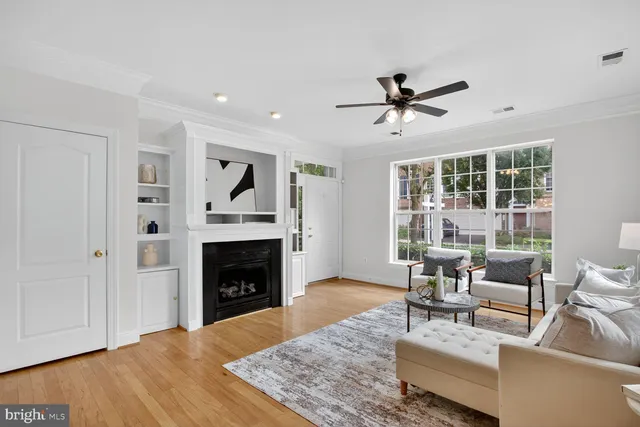 a living room with furniture a fireplace and a table