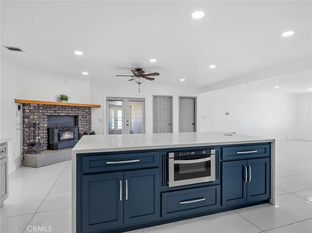 an empty room with wooden floor closet and windows