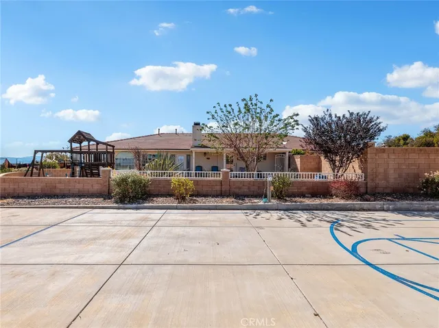 a bedroom with a balcony a bed and dresser with wooden floor