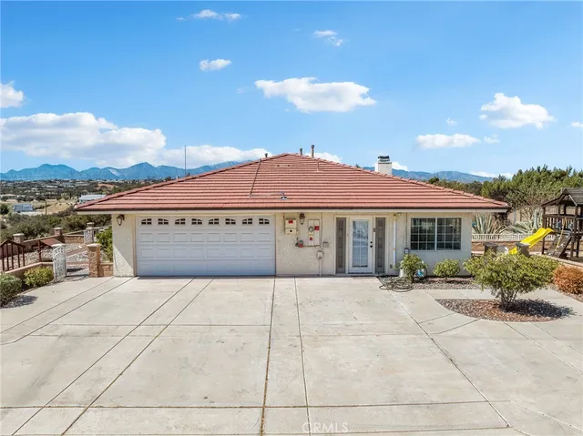 a view of kitchen with kitchen island granite countertop a refrigerator and a sink