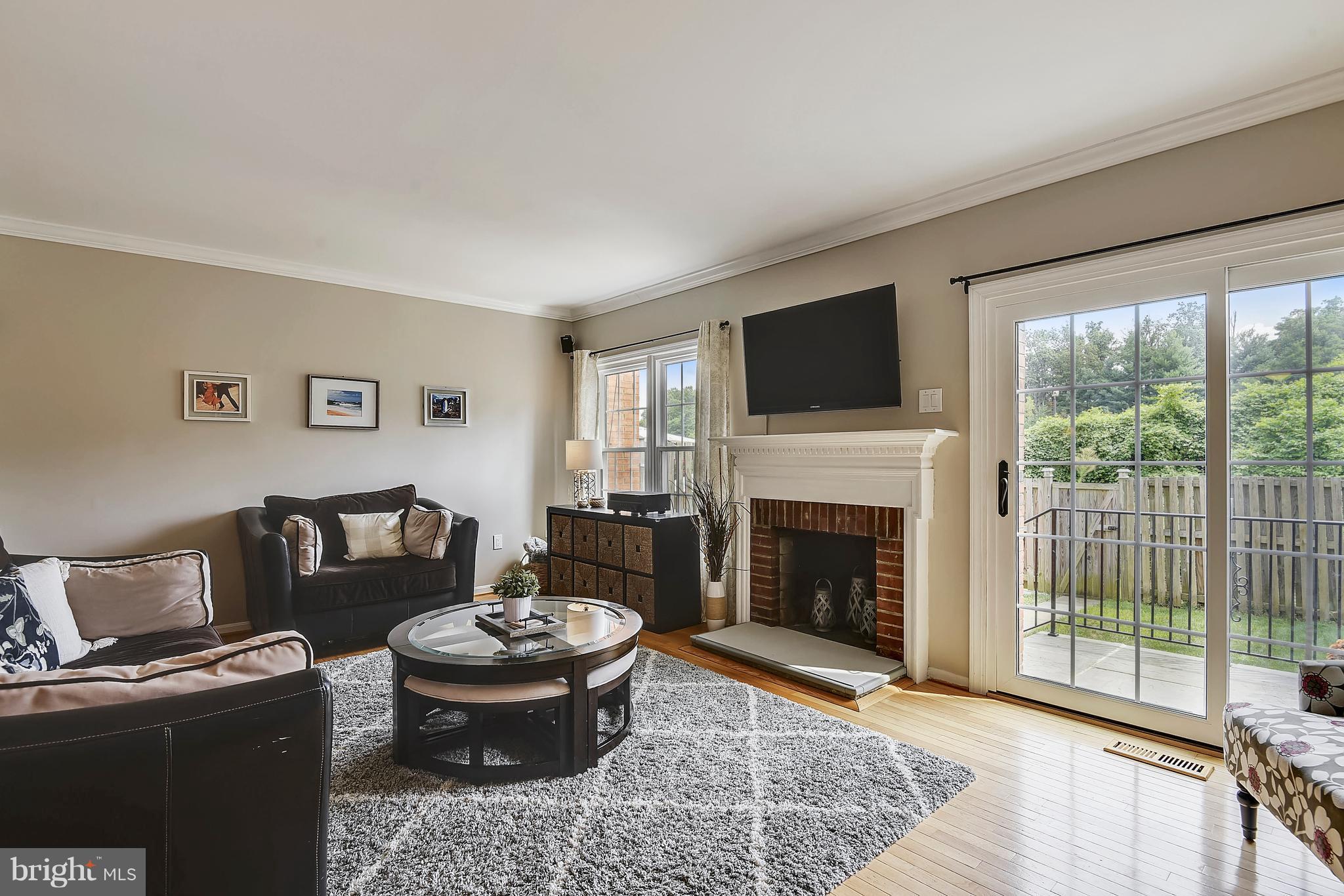 Living Room w/ Fireplace and Slider to Back Porch
