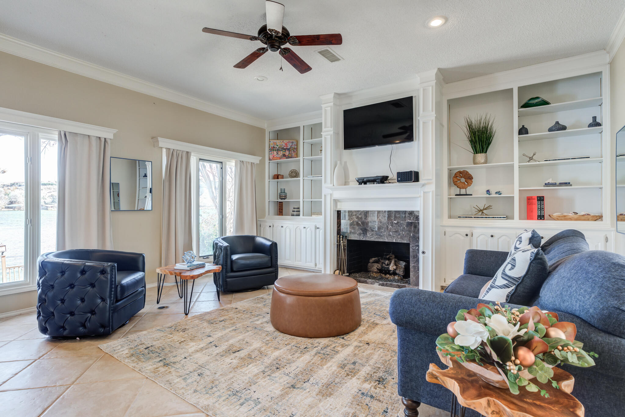 16 South Lake Shore Drive Ransom Canyon, TX 79366 - Photo 15 of 64 a living room with furniture a flat screen tv and a fireplace