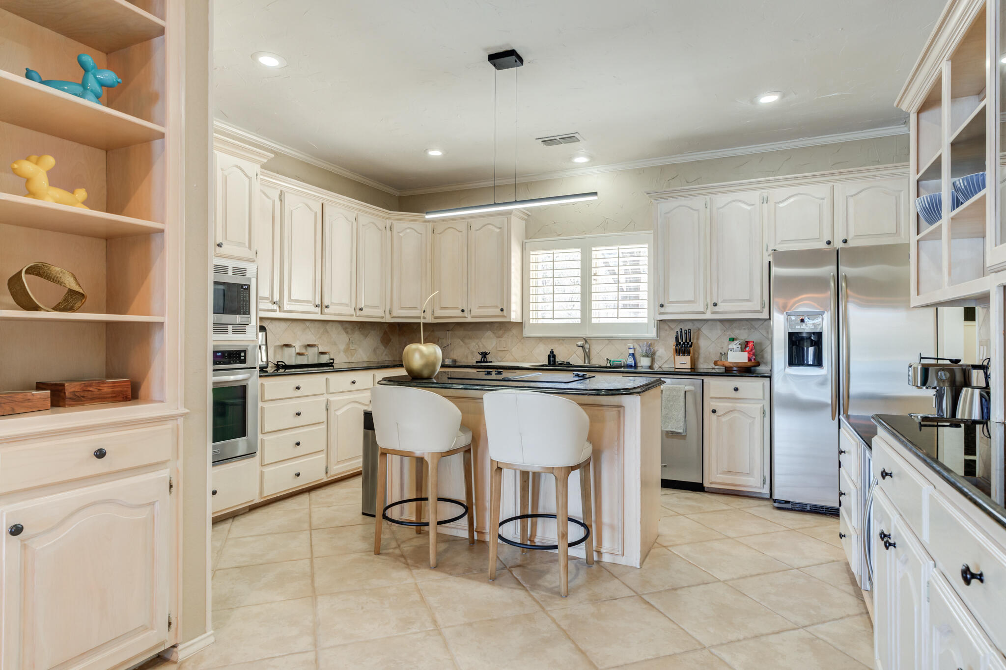 16 South Lake Shore Drive Ransom Canyon, TX 79366 - Photo 4 of 64 a kitchen with white cabinets and white appliances