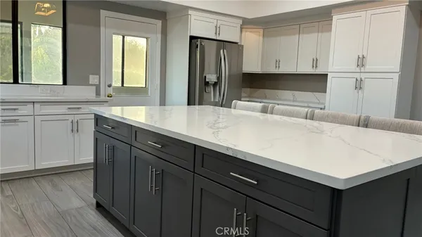 a kitchen with a sink cabinets and wooden floor