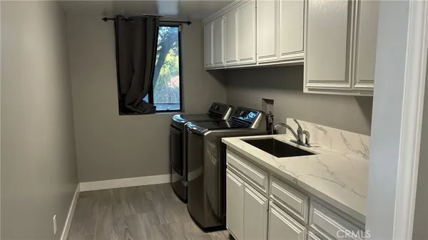 a kitchen with a sink a refrigerator and cabinets