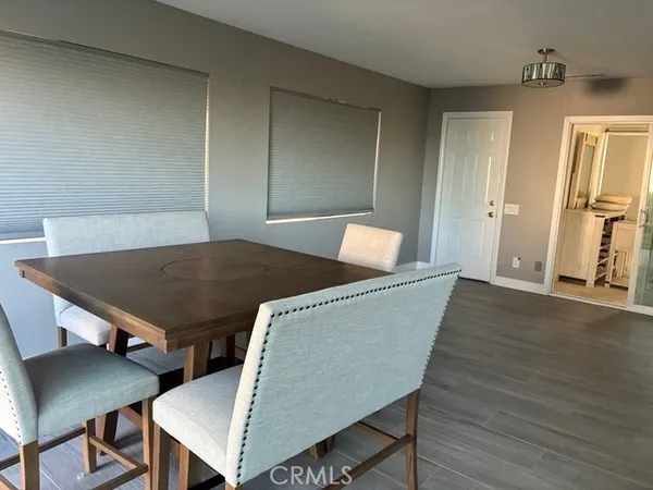 a living room with furniture rug and wooden floor