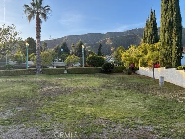 a view of a garden with a building in the background