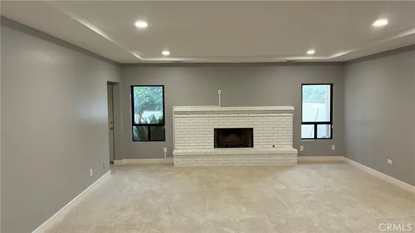 a view of an empty room with a fireplace