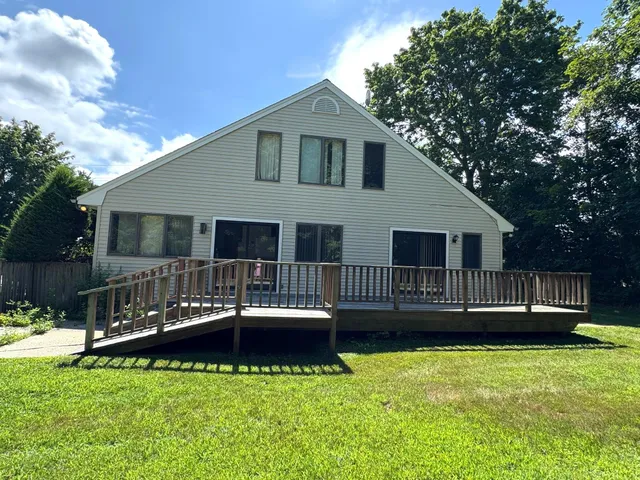 a front view of a house with a yard table and chairs