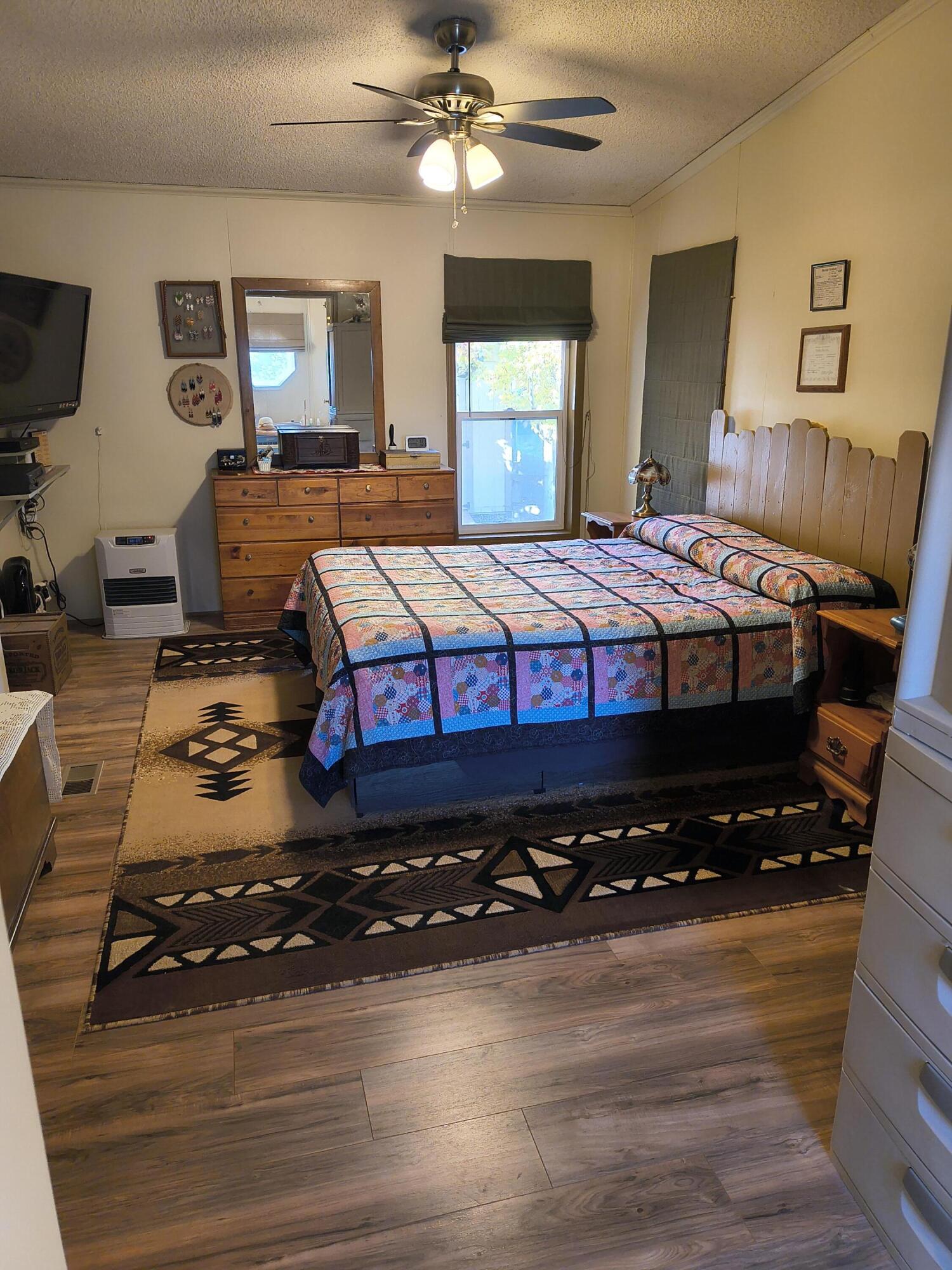 235 North Roosevelt Street Merrill, OR 97633 - Photo 21 of 27 a bedroom with a bed a dresser and painting on the wall