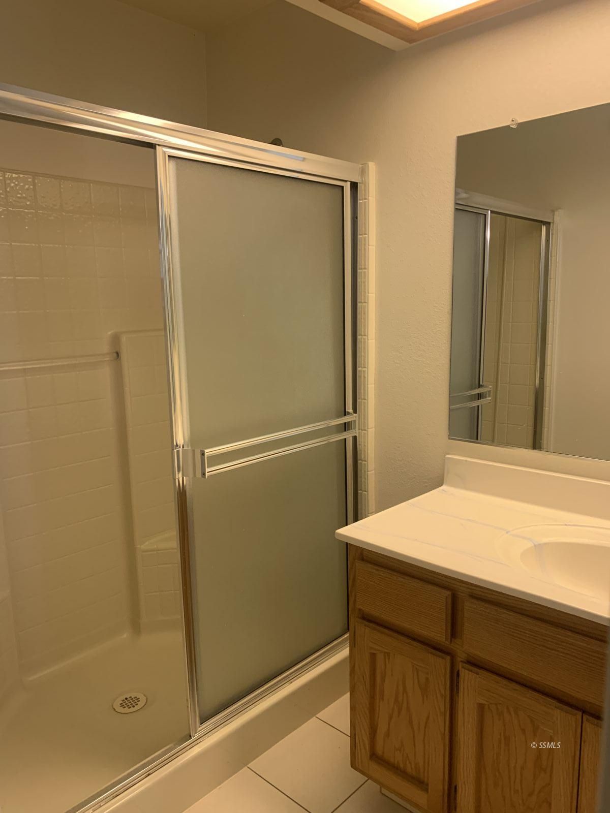 328 Ashton Street Ridgecrest, CA 93555 - Photo 20 of 28 a bathroom with a shower and a sink