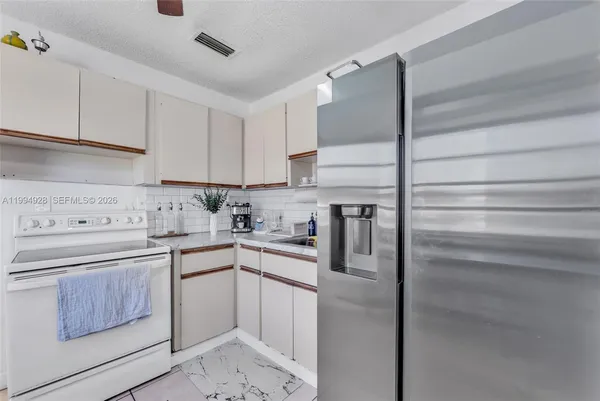 a kitchen with a sink stainless steel appliances and cabinets