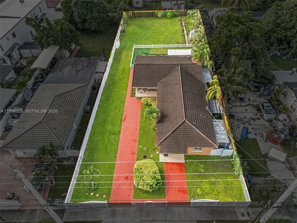 an aerial view of a tennis ground with large trees