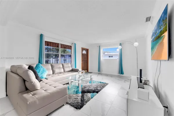 a living room with furniture and a flat screen tv