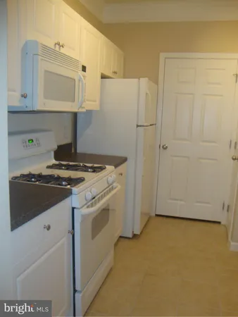 a kitchen with a stove and a refrigerator