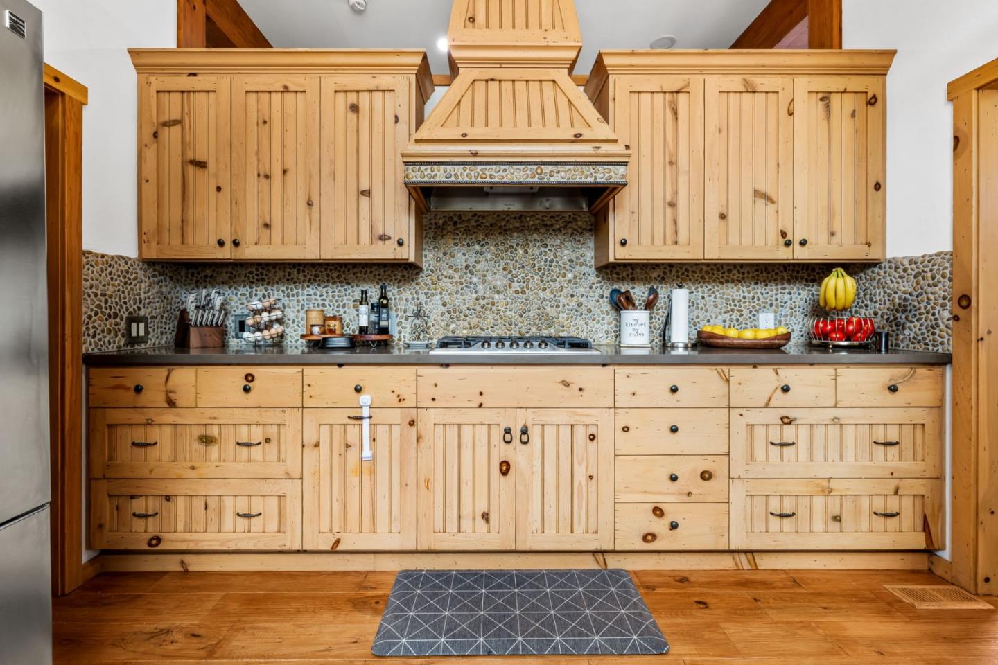 8697 Dyer Road Salinas, CA 93907 - Photo 23 of 94 a view of a kitchen with granite countertop white cabinets stainless steel appliances and wooden floor