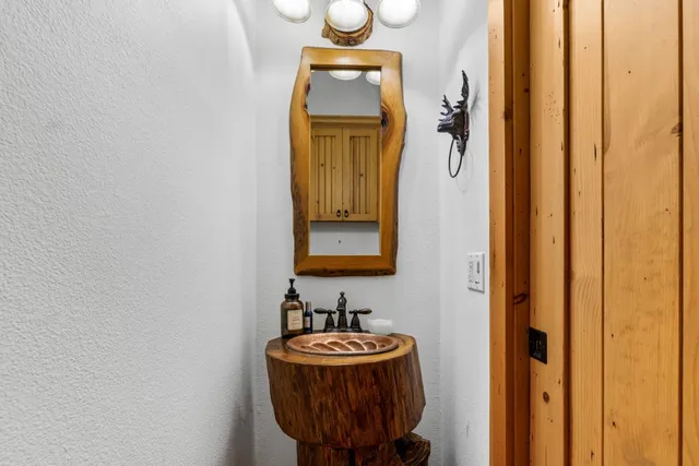 an aerial view of residential house with outdoor space and trees all around