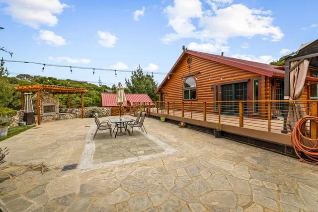 an aerial view of residential houses with outdoor space and trees