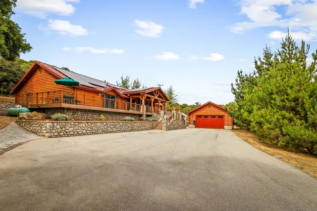 a view of a patio with table and chairs under an umbrella