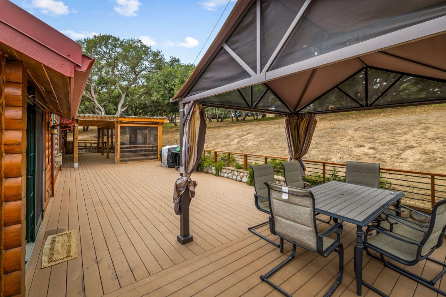 8697 Dyer Road Salinas, CA 93907 - Photo 74 of 94 a view of deck with table and chairs under an umbrella with wooden floor