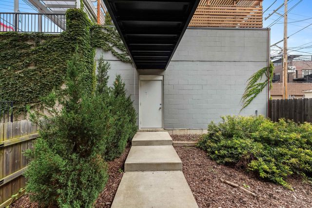 a view of a pathway of a house with a yard