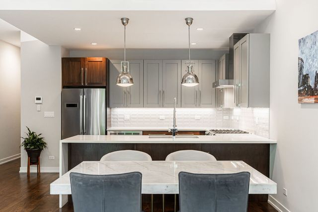 a kitchen with a sink and refrigerator