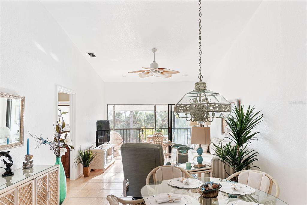 4260 Placida Road, Unit 12C Englewood, FL 34224 - Photo 14 of 57 a living room with furniture and a chandelier