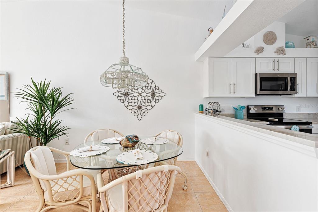4260 Placida Road, Unit 12C Englewood, FL 34224 - Photo 16 of 57 a living room with furniture a dining table and a fireplace