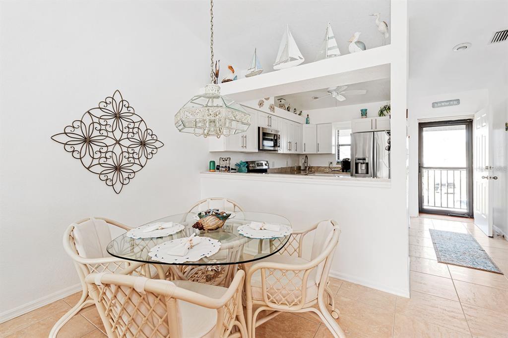 4260 Placida Road, Unit 12C Englewood, FL 34224 - Photo 17 of 57 a view of a dining room with furniture and chandelier