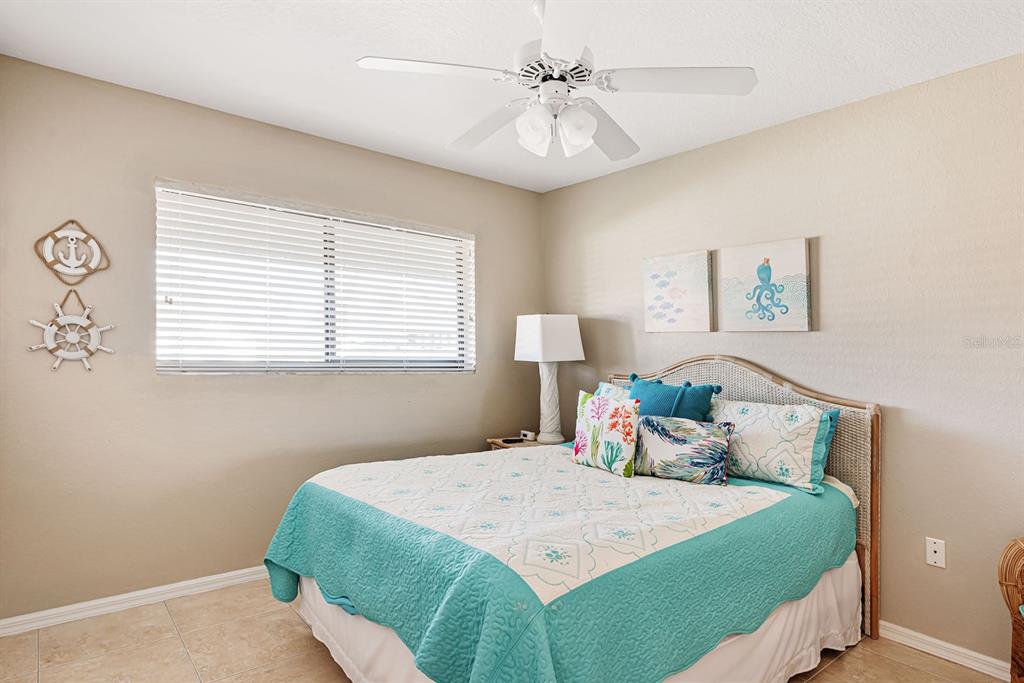 4260 Placida Road, Unit 12C Englewood, FL 34224 - Photo 23 of 57 a bedroom with a bed and a window