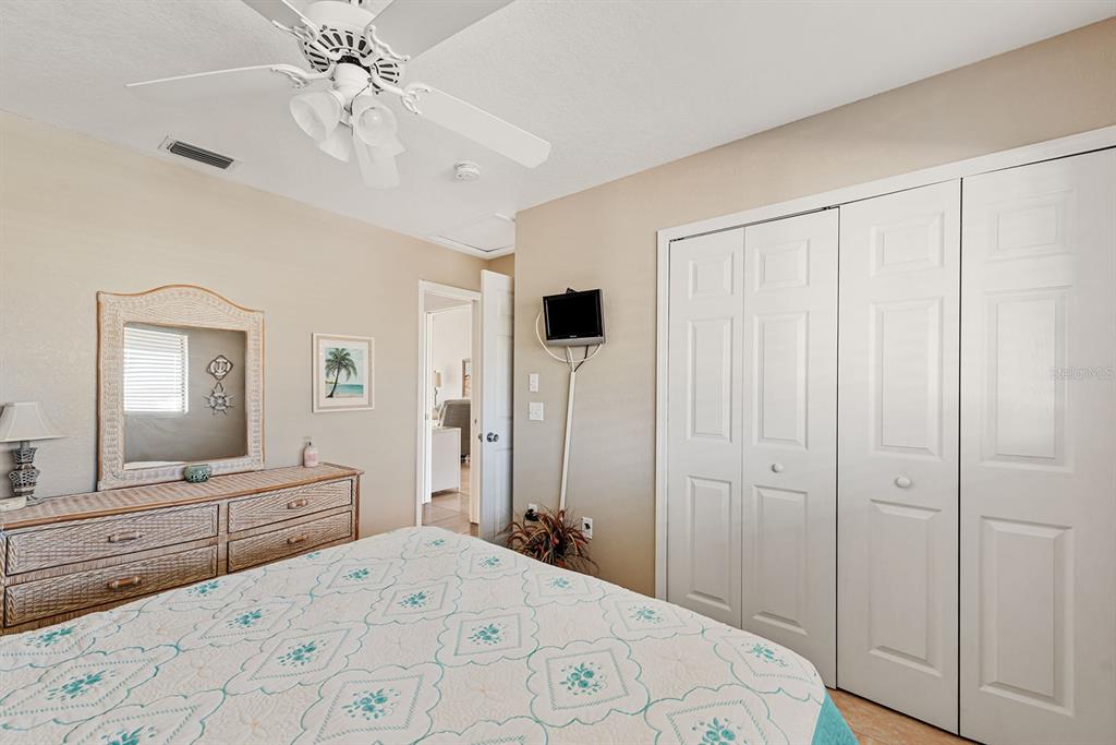 4260 Placida Road, Unit 12C Englewood, FL 34224 - Photo 25 of 57 a bedroom with a large bed and a mirror