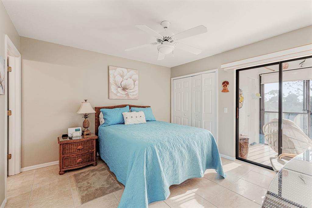 4260 Placida Road, Unit 12C Englewood, FL 34224 - Photo 29 of 57 a bedroom with a bed and a large window