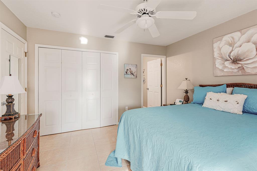 4260 Placida Road, Unit 12C Englewood, FL 34224 - Photo 30 of 57 a bedroom with a bed and a chandelier