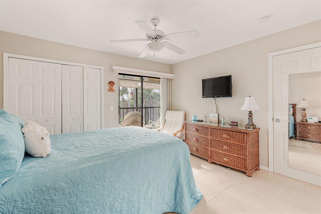 4260 Placida Road, Unit 12C Englewood, FL 34224 - Photo 31 of 57 a spacious bedroom with a large bed and a flat screen tv