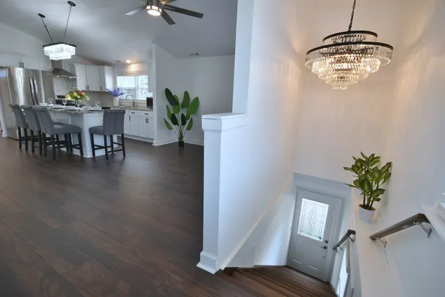 a kitchen with stainless steel appliances granite countertop a sink dishwasher a stove a refrigerator a microwave oven with a dining table and chairs