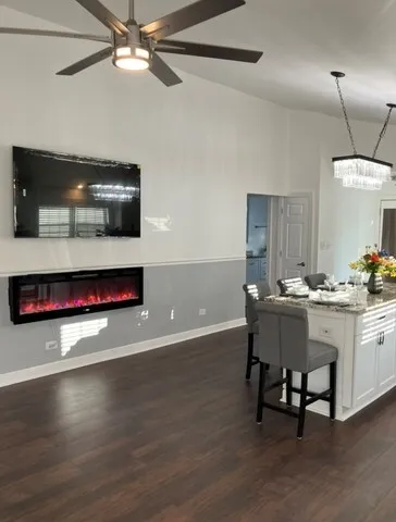 a view of a room with wooden floor and chandelier