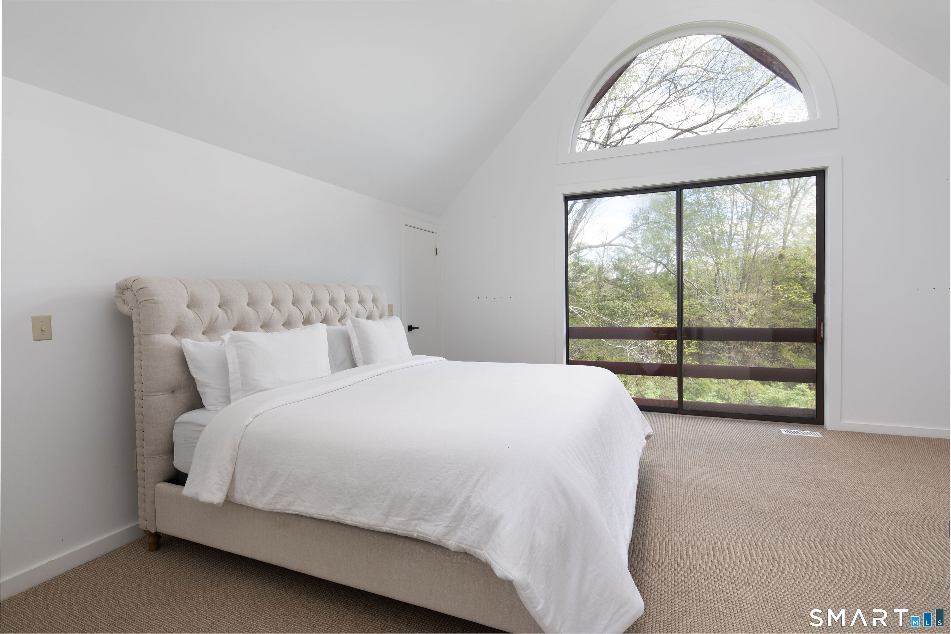 290 Indian Mountain Road Salisbury, CT 06039 - Photo 12 of 16 a large bed sitting in a bedroom next to a window
