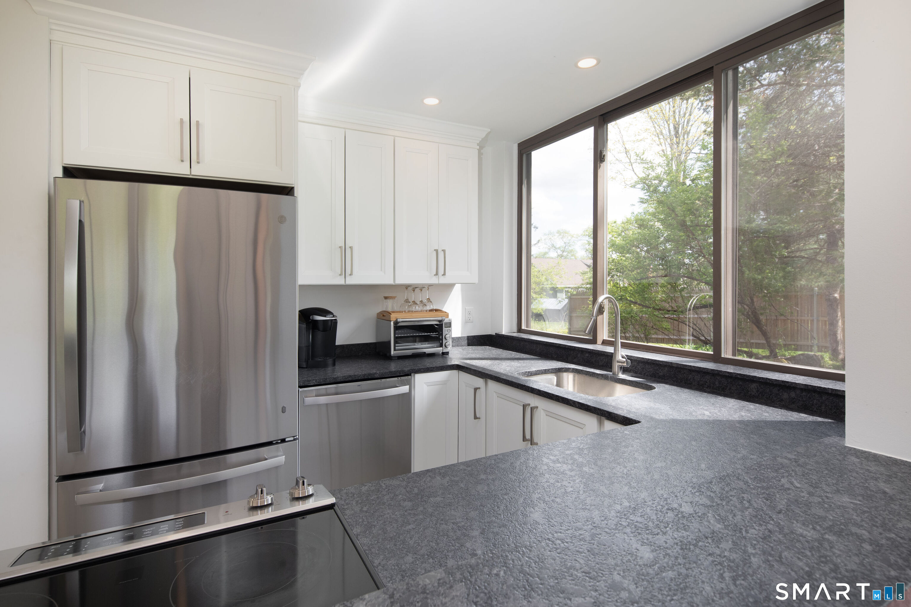 290 Indian Mountain Road Salisbury, CT 06039 - Photo 5 of 16 a kitchen with stainless steel appliances granite countertop a refrigerator a sink and a stove with white countertops