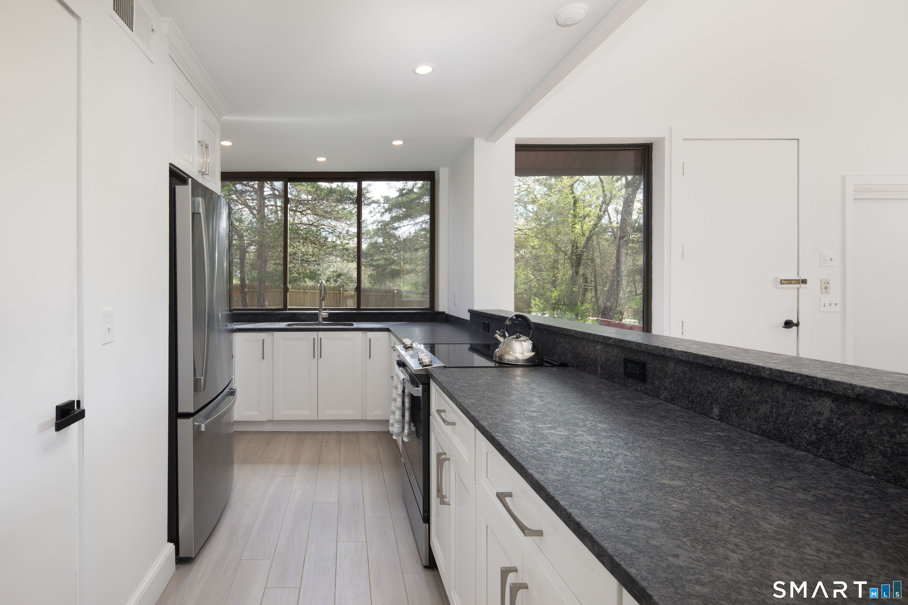 290 Indian Mountain Road Salisbury, CT 06039 - Photo 6 of 16 a view of a kitchen with a sink and dishwasher with wooden floor