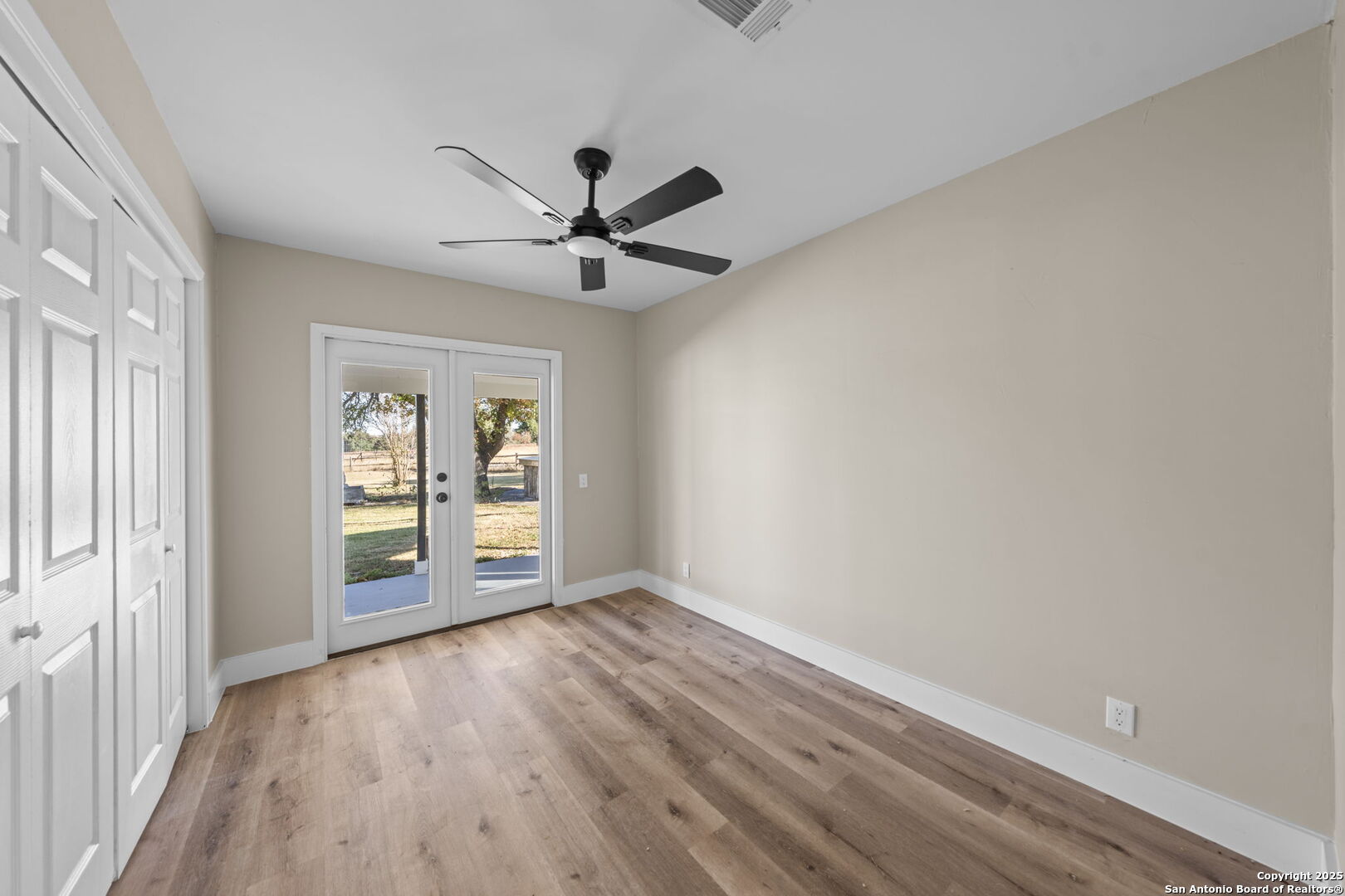 28 Ruger Road Fredericksburg, TX 78624 - Photo 11 of 46 wooden floor in an empty room with a window
