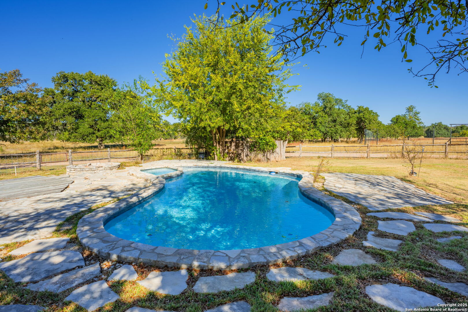 28 Ruger Road Fredericksburg, TX 78624 - Photo 15 of 46 a view of a swimming pool with an outdoor space and seating area