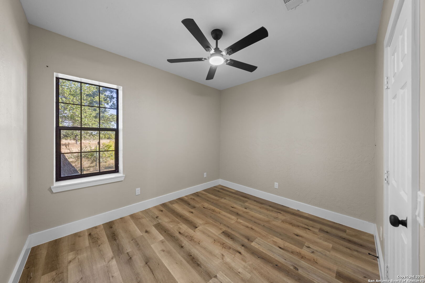 28 Ruger Road Fredericksburg, TX 78624 - Photo 28 of 46 wooden floor in an empty room with a window