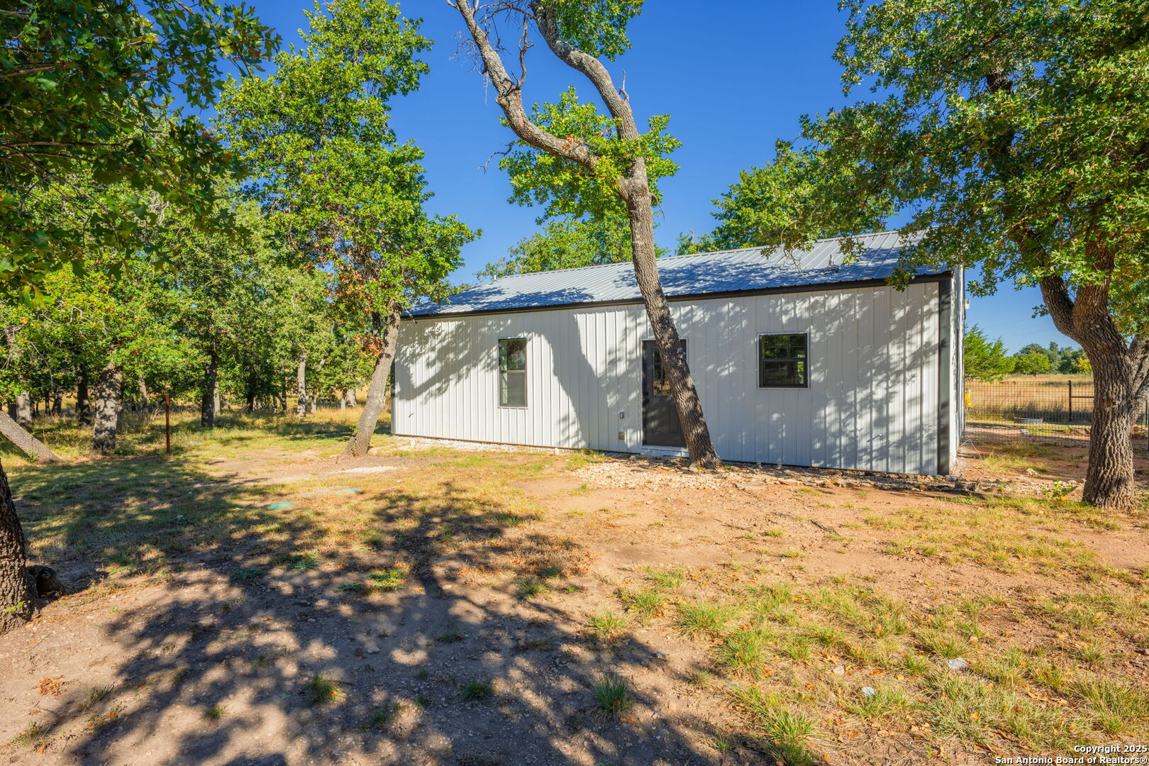 28 Ruger Road Fredericksburg, TX 78624 - Photo 34 of 46 a bathroom with a sink and yard with wooden fence