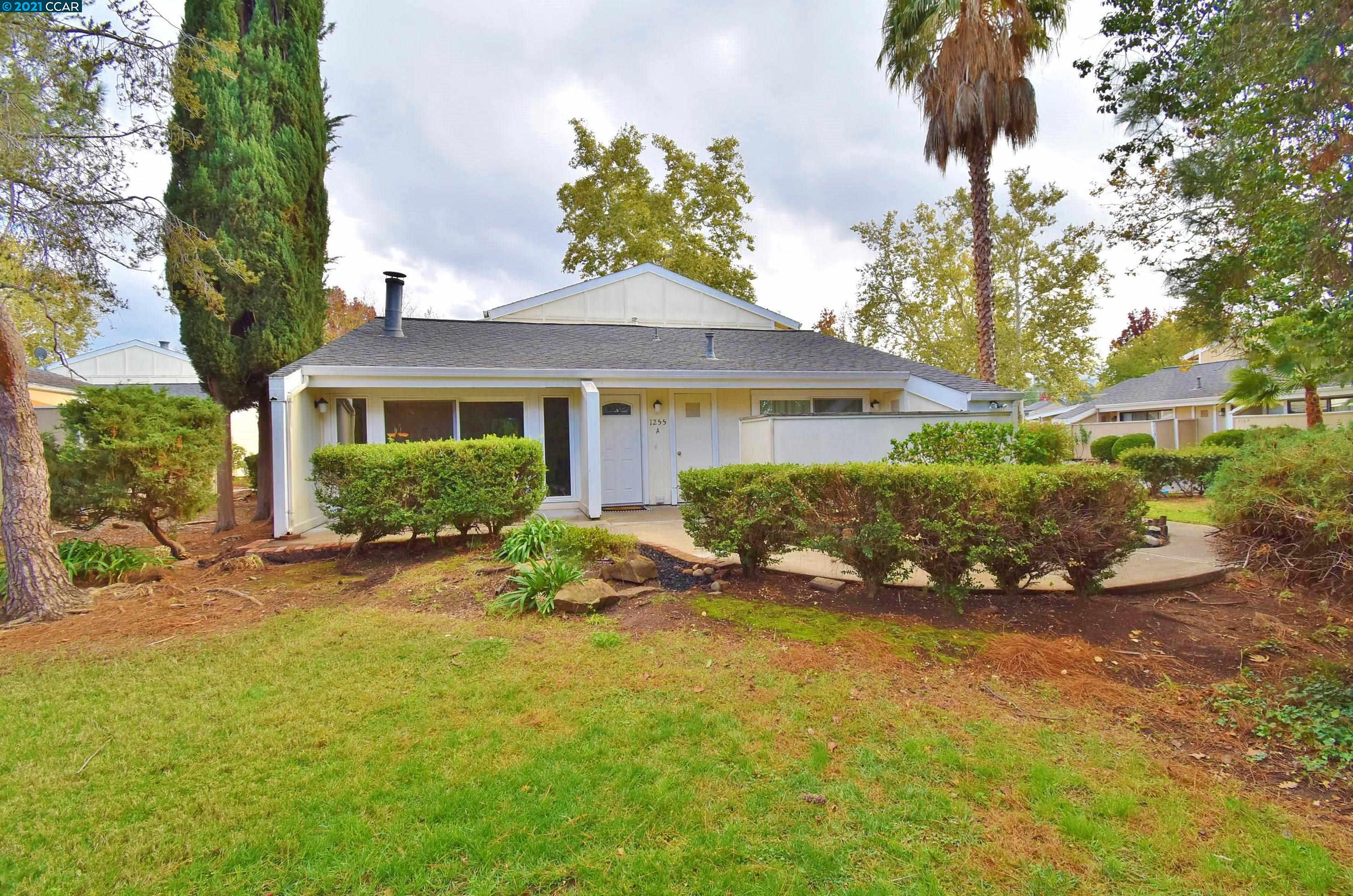 1255 Kenwal Road, Unit A Concord, CA 94521 - Photo 1 of 1 a view of a house with a garden and pathway